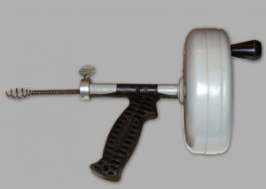 A handheld drain auger