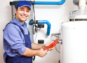 A plumber working on a water heater