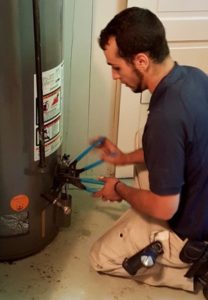 A plumber repairing a water heater